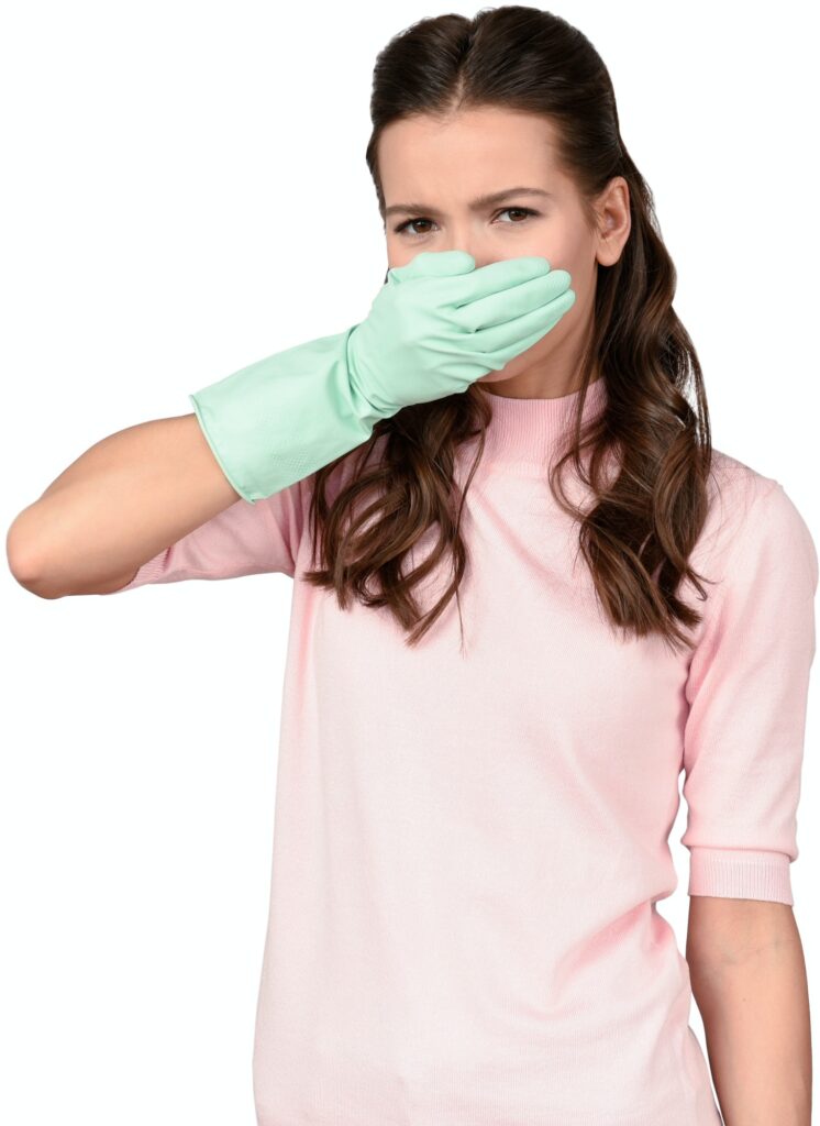a woman wearing surgical gloves and covering her mouth